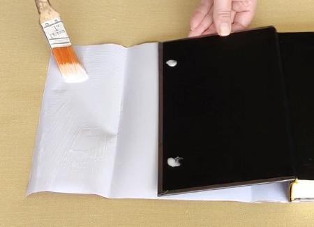 Brushing glue on the dust jacket flap