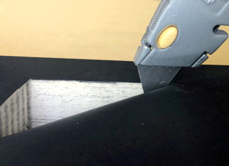 Cutting the endpaper to reveal the cavity